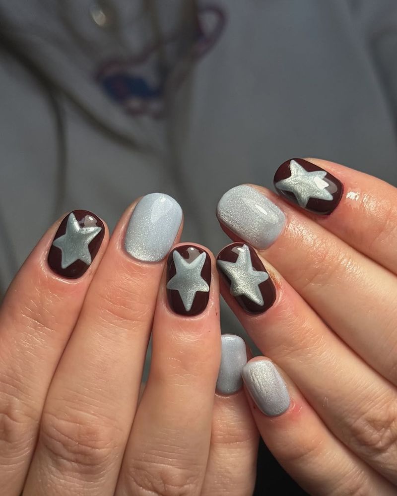 ongles courts automne base gel marron avec nail art étoile yeux de chat gris