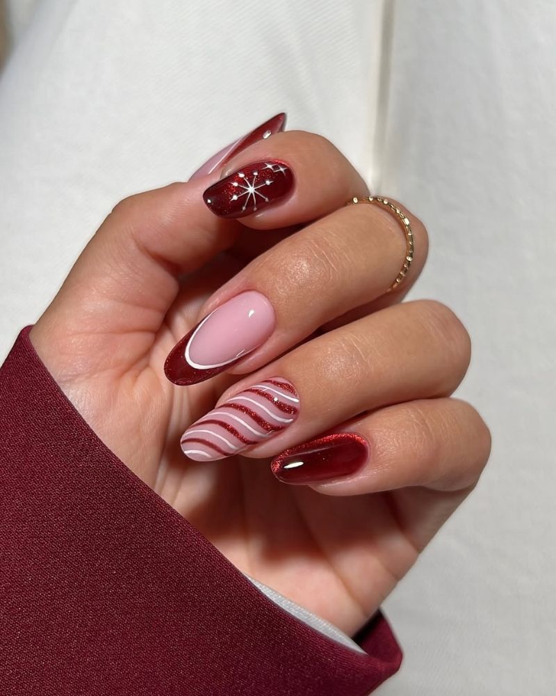 vernis œil de chat rouge profond sur motifs d'ongles festifs