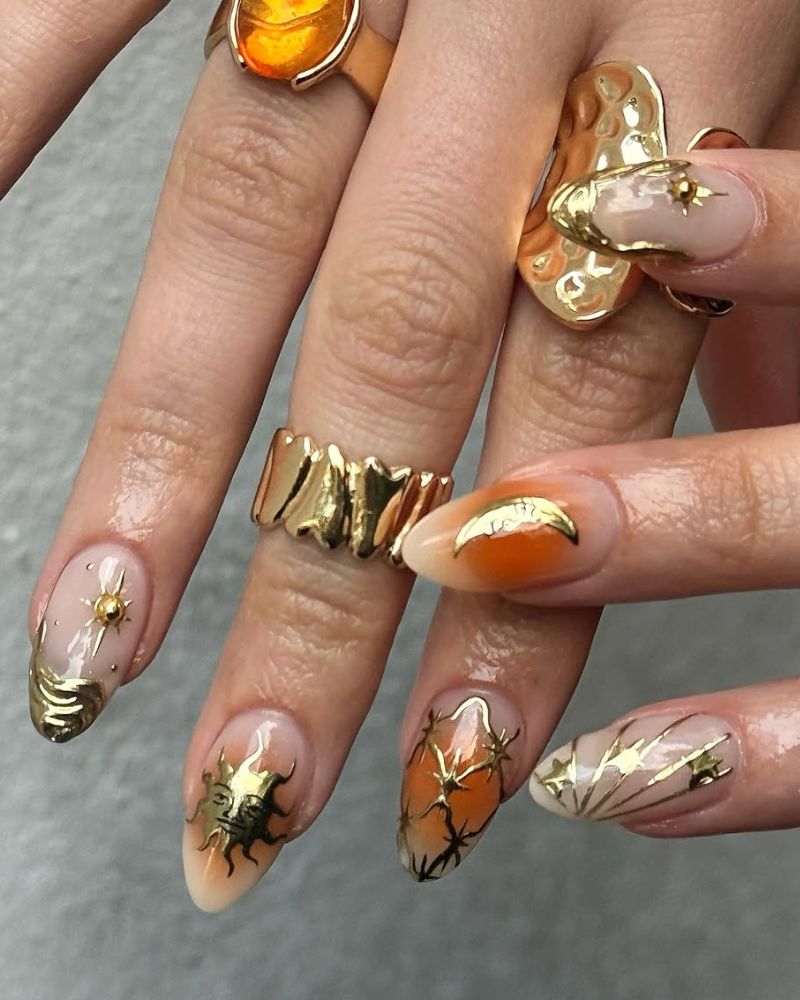 manucure céleste avec étoiles et lune en nail art doré