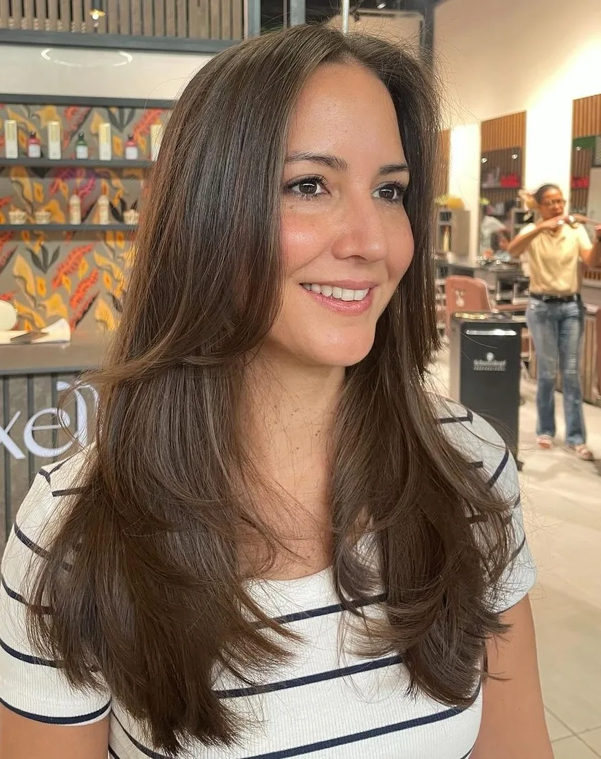 Cheveux longs avec frange longueur menton fondue dans des couches effilées