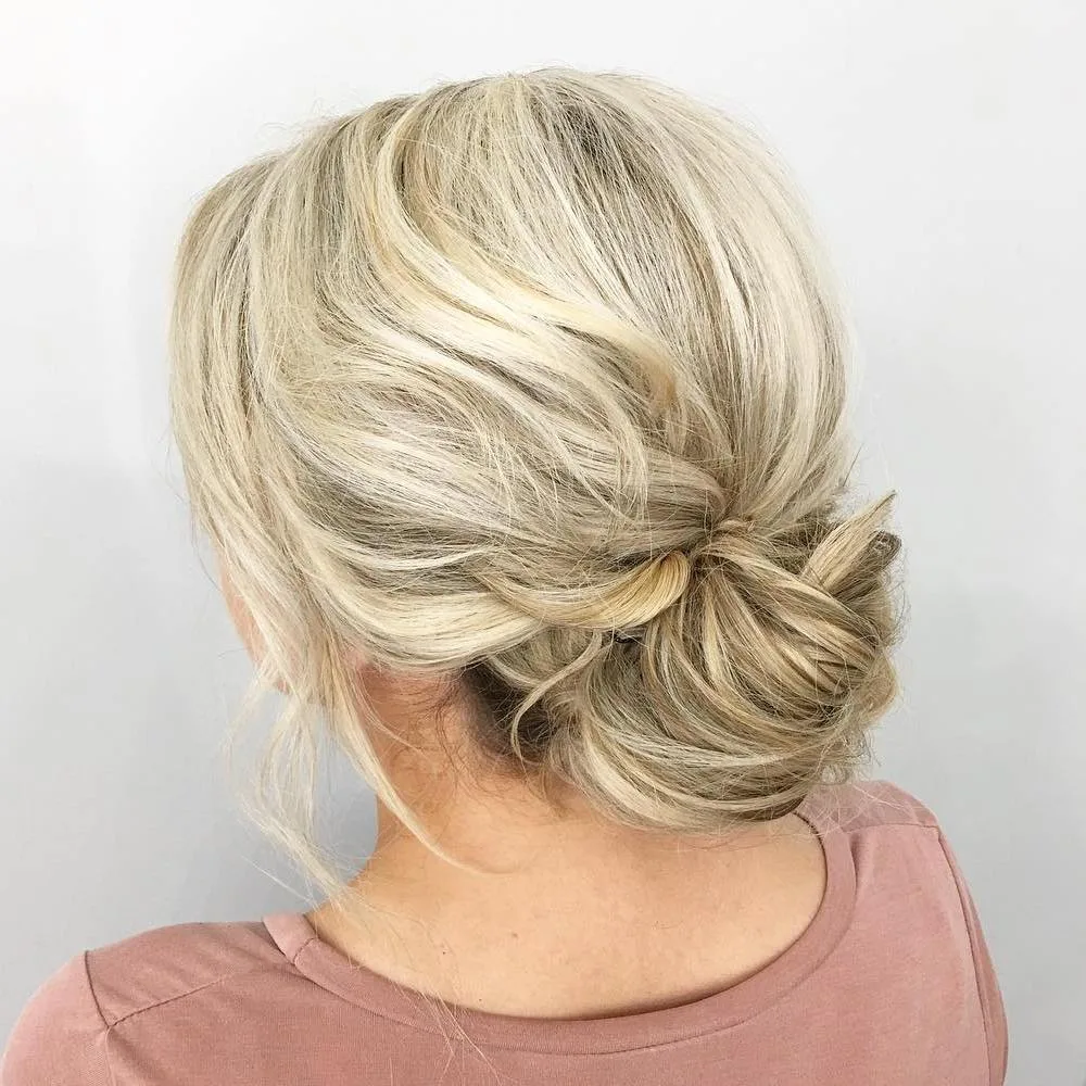 Chignon bas flou et relâché sur cheveux blonds