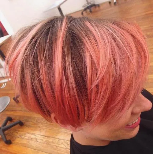 Carré rose corail avec racines brunes, coupe courte dégradée