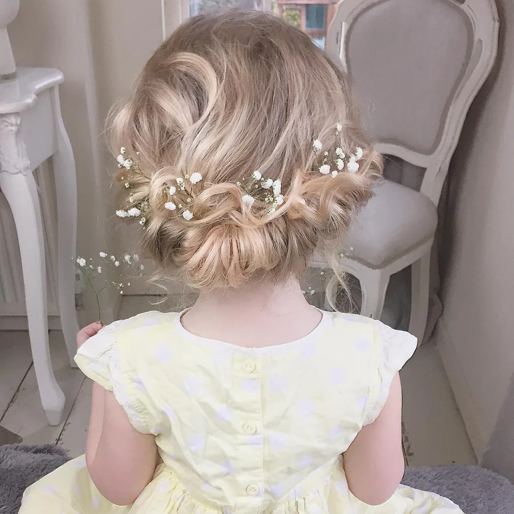 Chignon flou bouclé pour petite fille avec gypsophile, coiffure de cérémonie