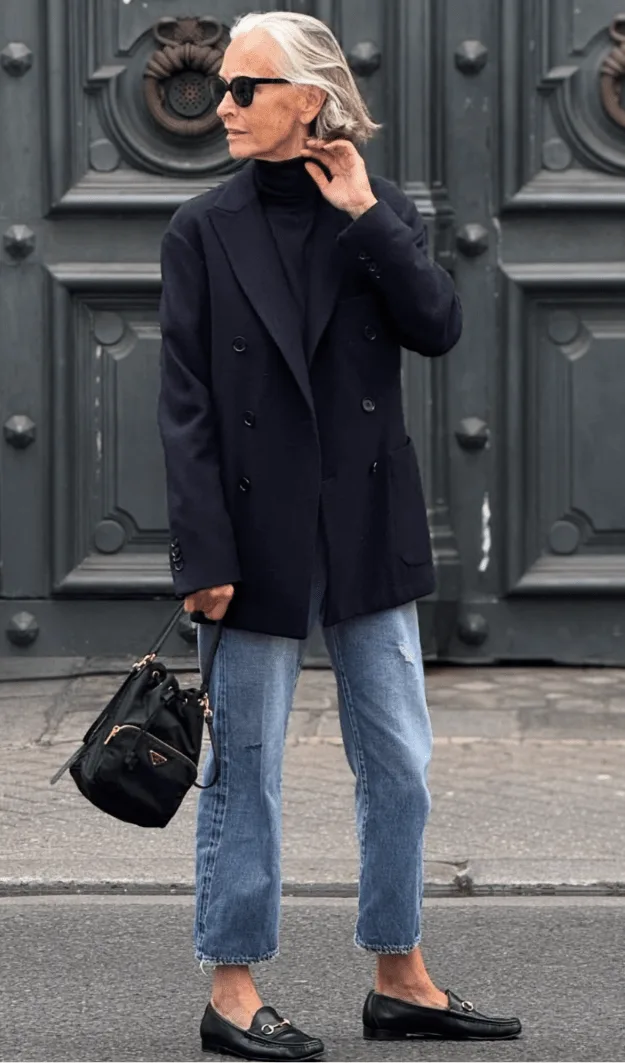 Femme de plus de 50 ans en manteau structuré à épaule marquée, style automne élégant