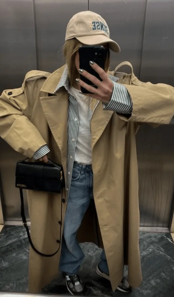 Look trench beige avec tee-shirt rayé, jean large et casquette, allure parisienne