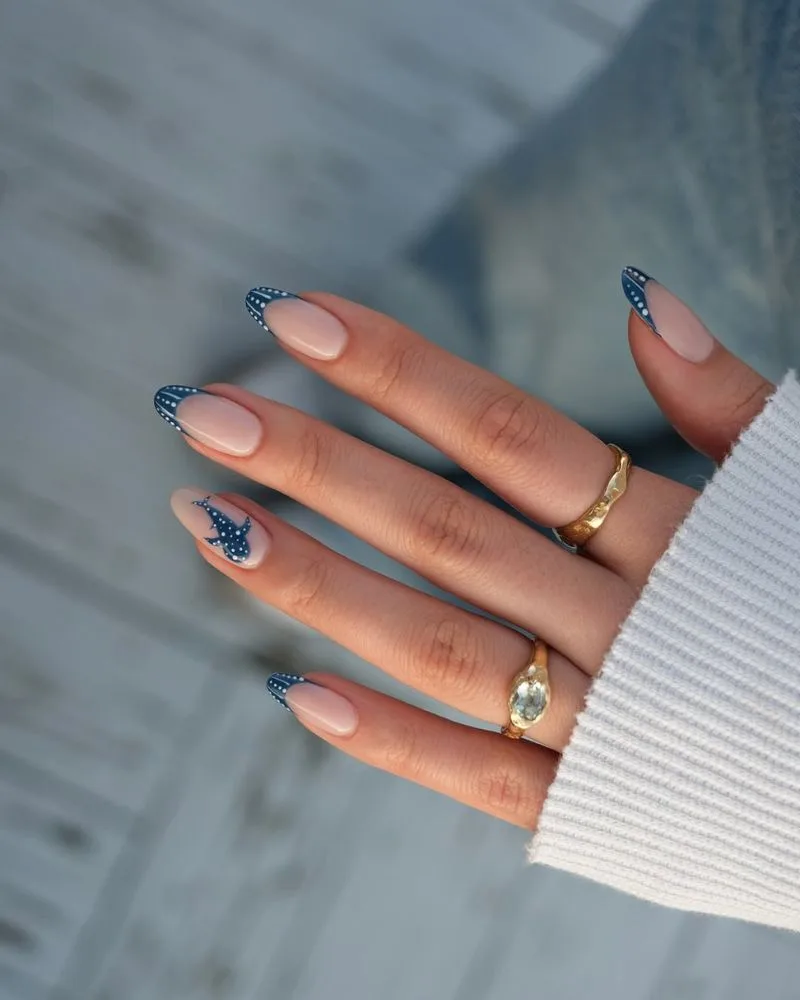 Manucure french bleu marine à pois blancs avec requin-baleine peint sur l'ongle accent