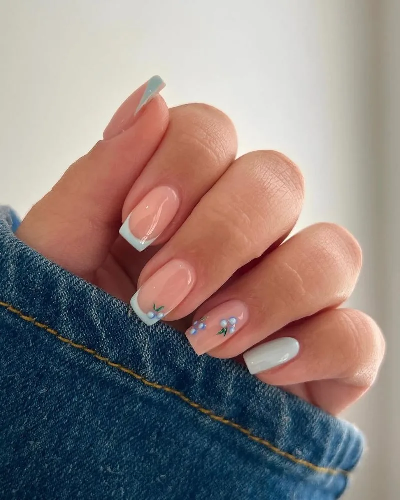 Ongles amande fine french bleu clair avec nail art myrtilles minimaliste