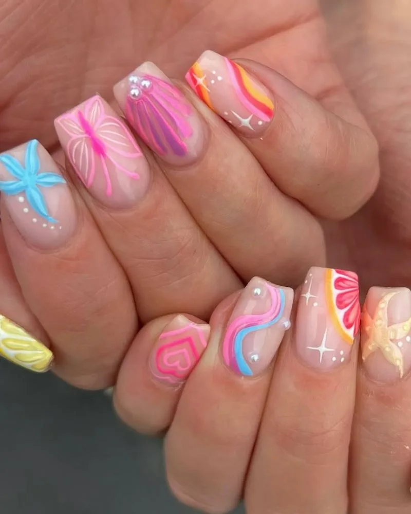 Ongles base nude avec nail art océan coloré, étoile de mer et vagues