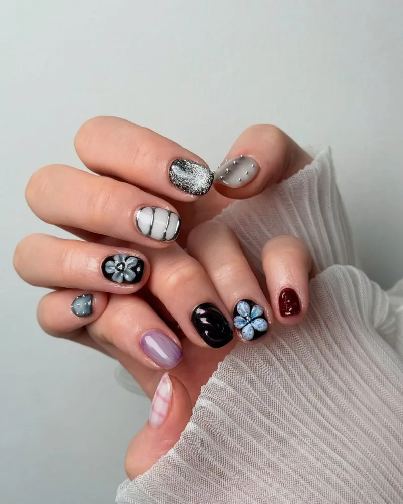Ongles dépareillés motifs sombres et fleurs