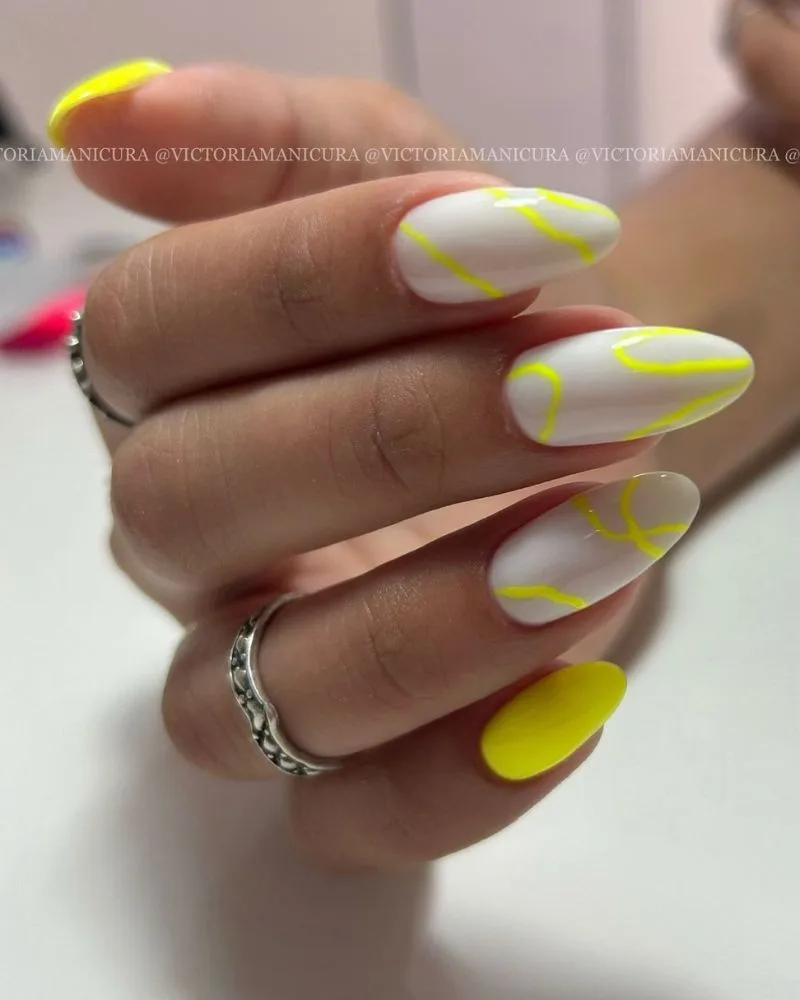 ongles néon jaune avec ongles blancs et lignes ondulées graphiques