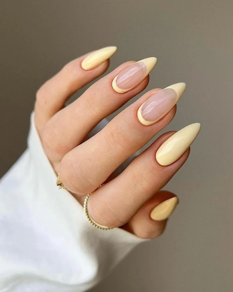 ongles stiletto jaune pastel avec french élégante pour l'été