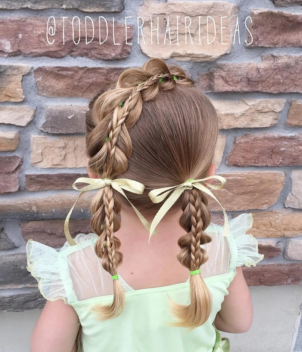 Petite fille avec couettes tressées ornées de rubans coordonnés