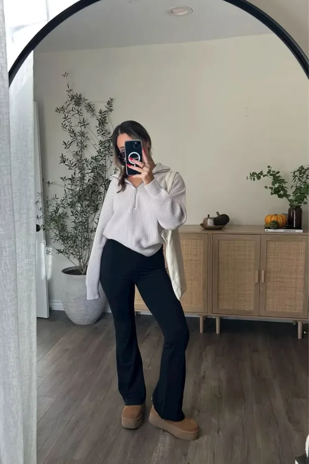 Tenue cardigan clair boutonné avec pantalon flare noir et bottines rentrée