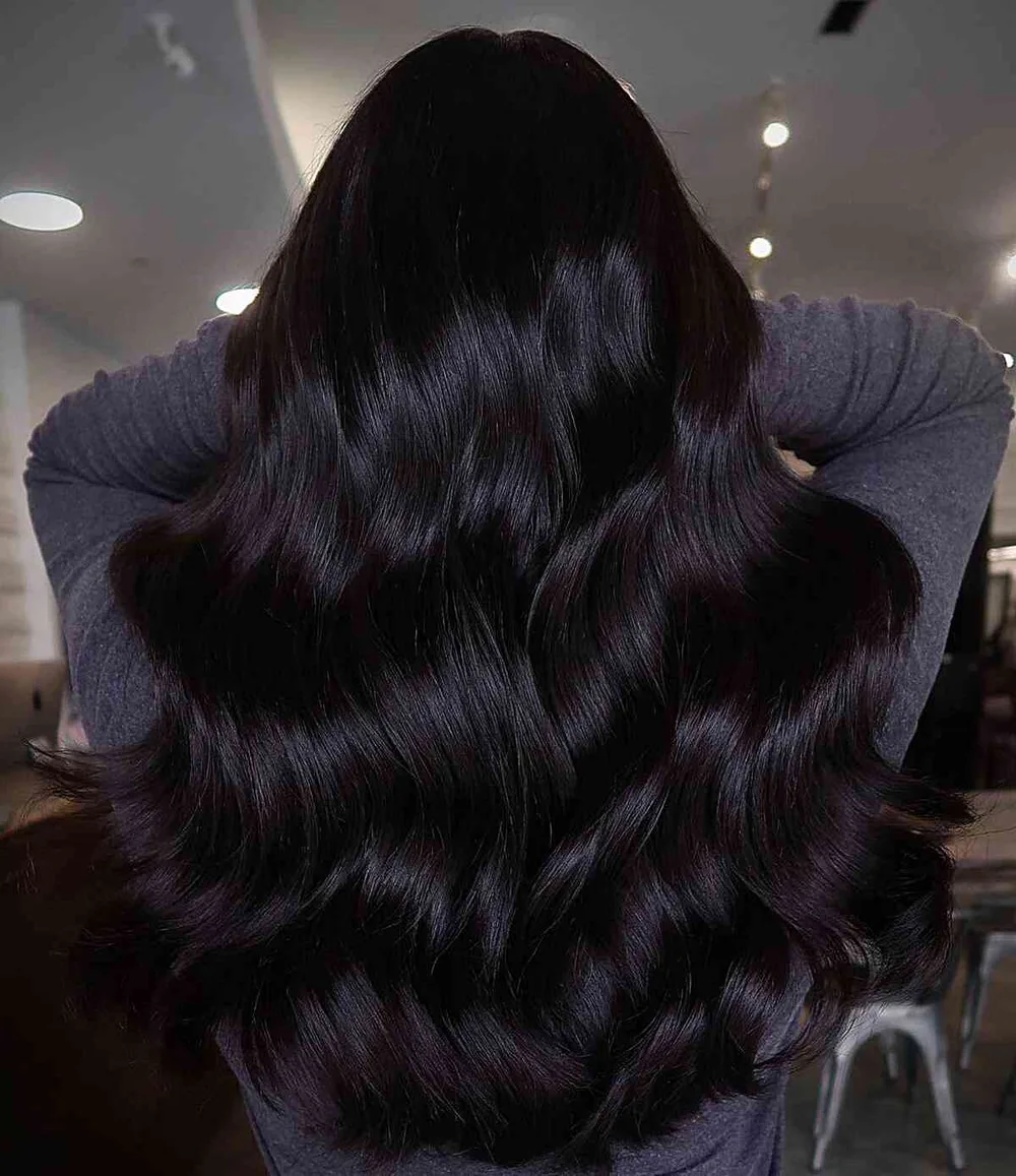 Cheveux chocolat noir intense très foncés et brillants, longues ondulations
