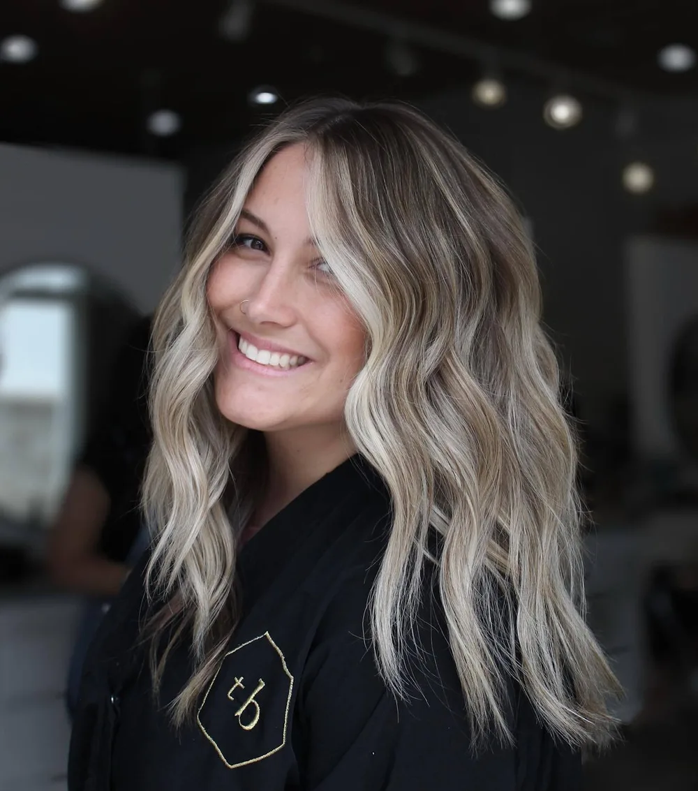 Fins rubans blonds encadrant le visage sur base brune ondulée