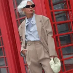Le tailleur beige porté avec une chemise bleu ciel portée par une femme élégante