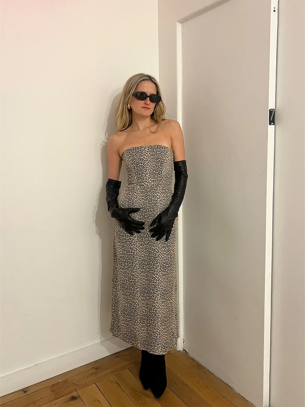 Robe longue léopard ajustée portée avec des bottines noires et des gants