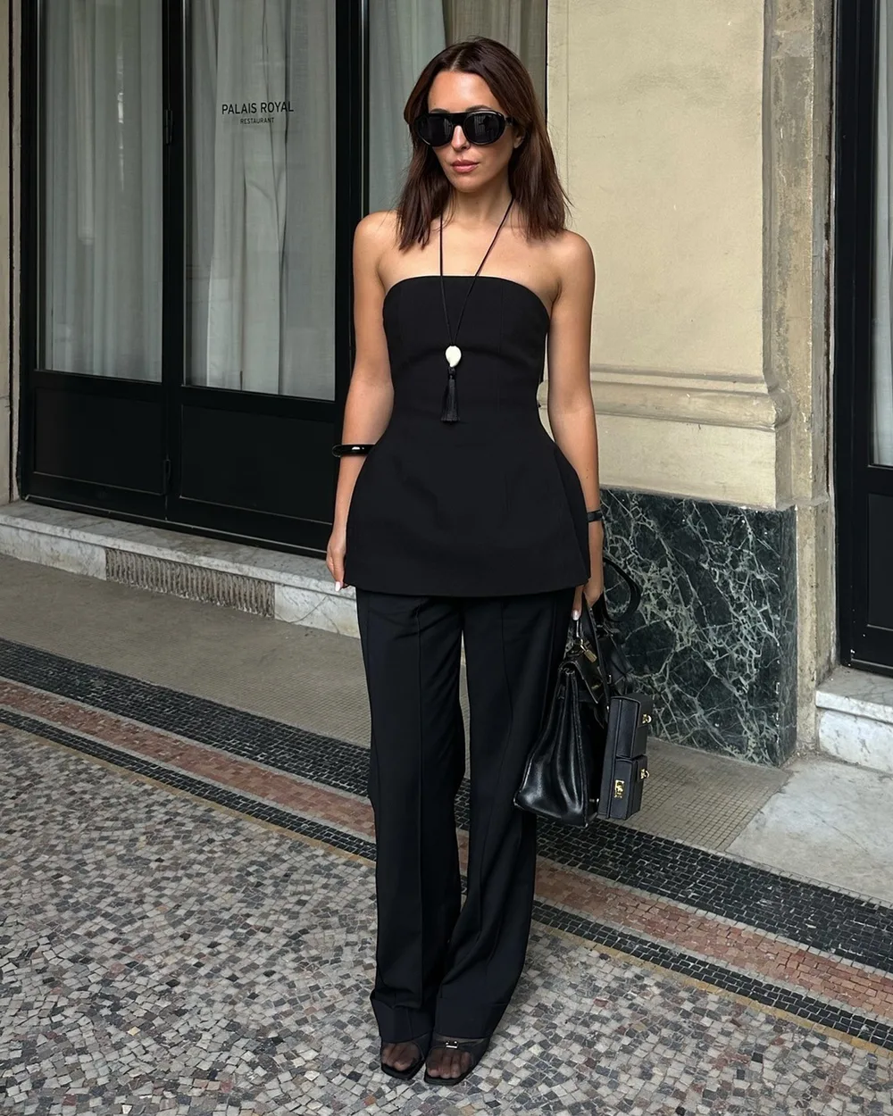 Top péplum noir sans manches avec pantalon noir droit et chaussures en résille