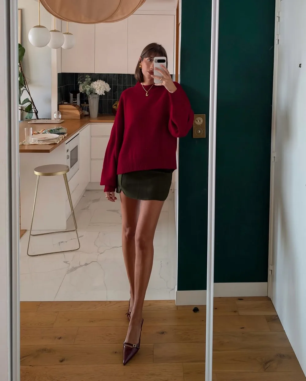 Pull rouge bordeaux avec mini-jupe kaki et chaussures pointues